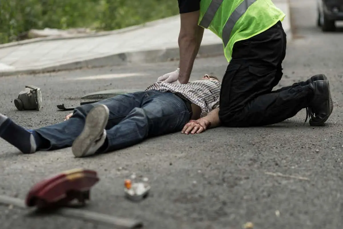 person getting car accident treatment on the road