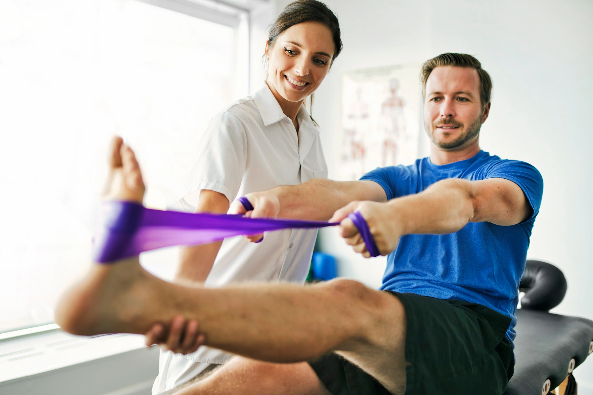Physical therapist guiding an athlete through rehab exercises for sports injuries and running injuries to improve strength, mobility, and recovery.